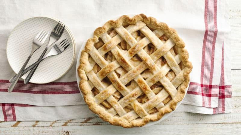 Apple pie from above with plates and forks